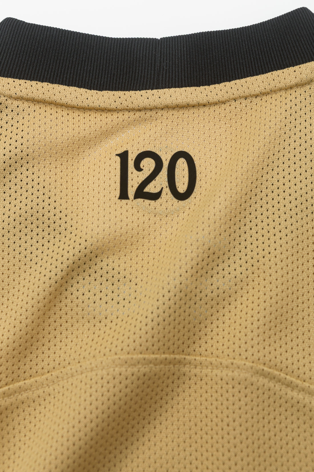 Close-up of the number 120 on the back of the Sporting Total 90 26/27 Kids' Alternate Jersey.