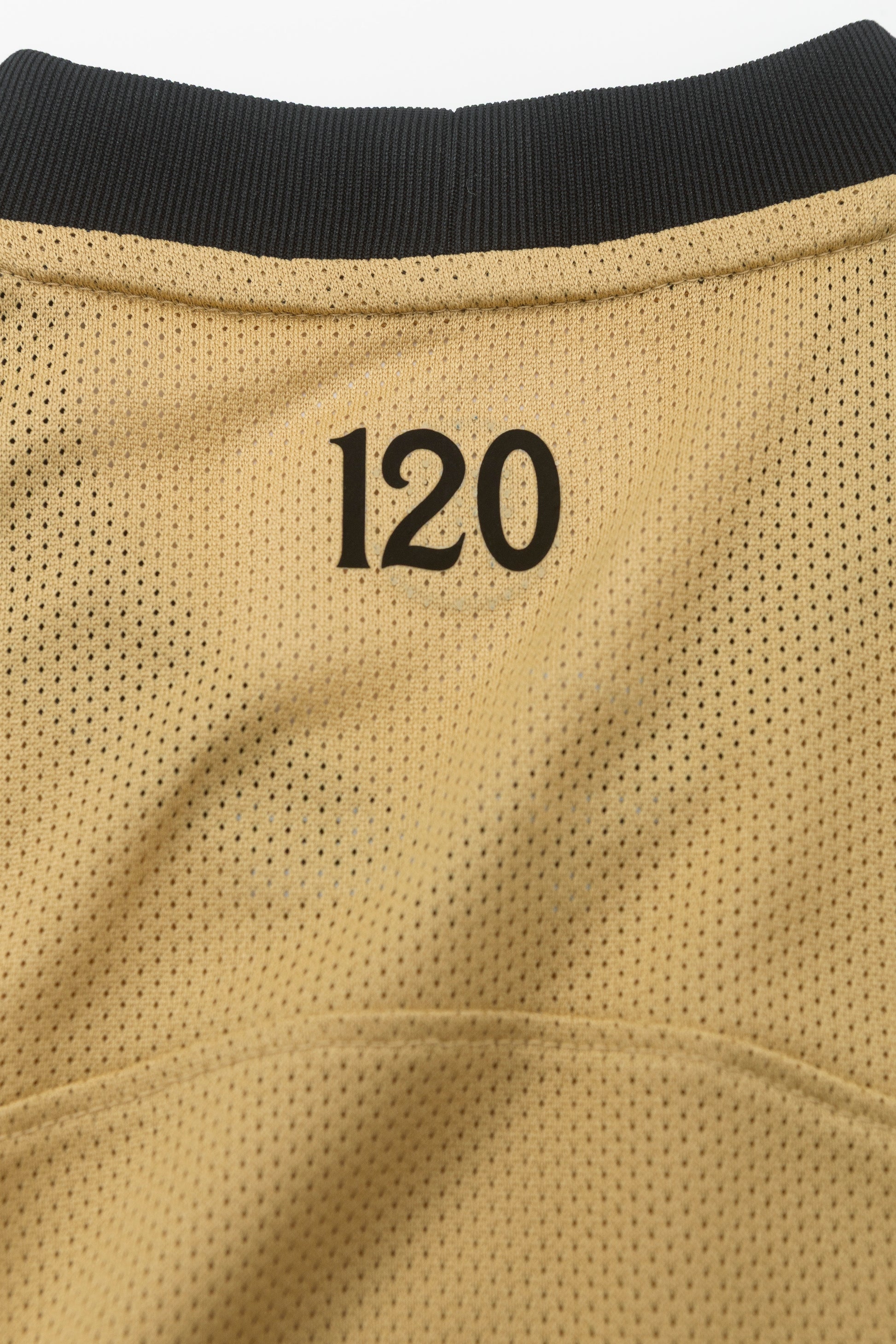 Close-up of the number 120 on the back of the Sporting Total 90 26/27 Kids' Alternate Jersey.