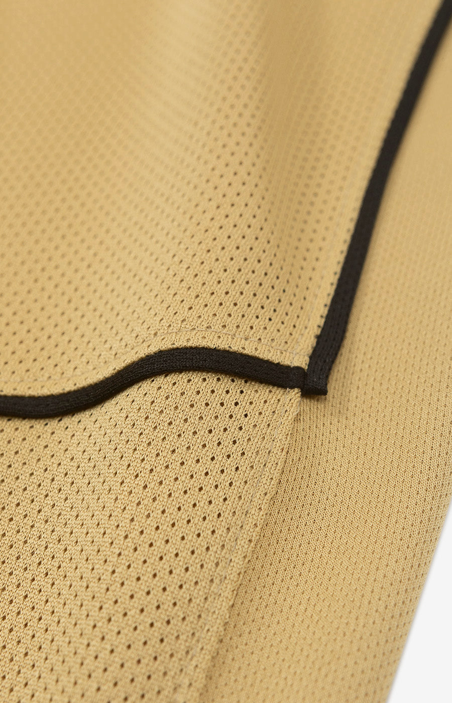Close-up of the hem with black trim on the Sporting Children's Total 90 26/27 Alternate Jersey.