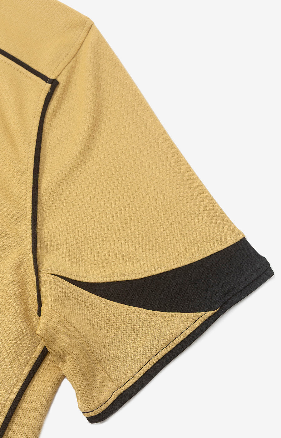 Détail de la manche dorée rehaussée d'une touche noire sur le maillot alternatif Total 90 du Sporting pour la saison 26/27.