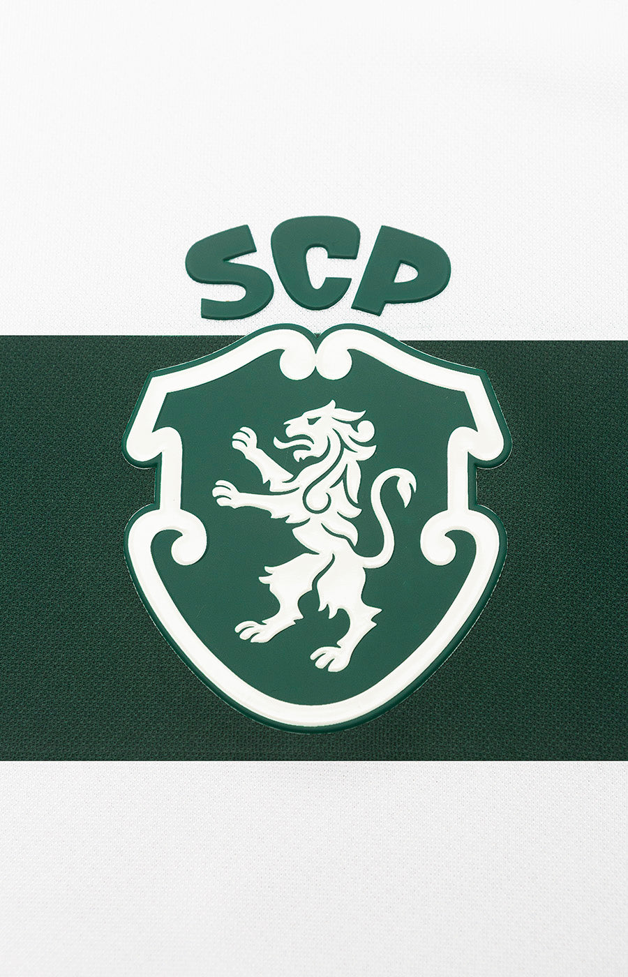 Close-up of the white Sporting crest on the green background of the 26/27 Home Jersey.