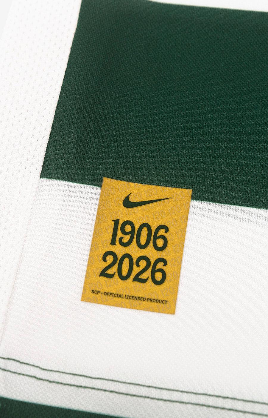 Commemorative 1906–2026 Nike label from Sporting's 26/27 Home Jersey.