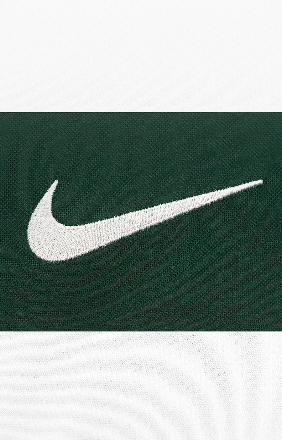 Close-up of the Nike swoosh on the green Sporting 26/27 Home Jersey.
